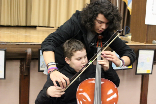 <p>Members of Amundsen High School's orchestra provide music lessons to students at McPherson Elementary.</p>

