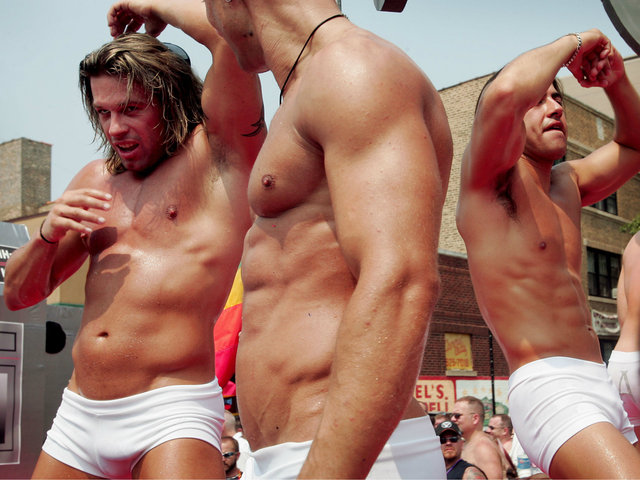 <p>Parade participants dance on a float as it travels through the city's gay district during the 36th annual Gay and Lesbian Pride Parade on June 26, 2005.</p>
