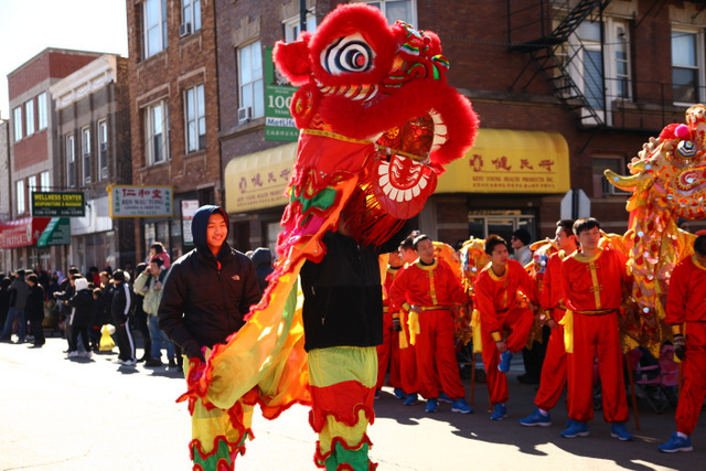 <p>Parade participants dance in a Chinese dragon puppet in Chicago's Chinatown.</p>
