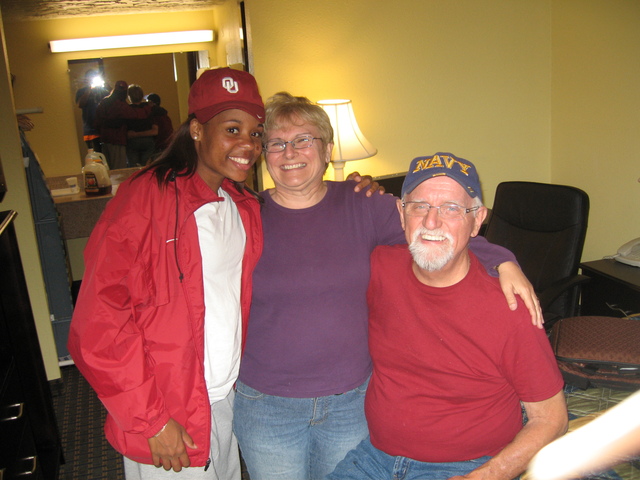 <p>Dominique Jacobs (left) poses with Margaret Klaus and her husband, Bob, while Jacobs was a student-athlete at the University of Oklahoma.</p>
