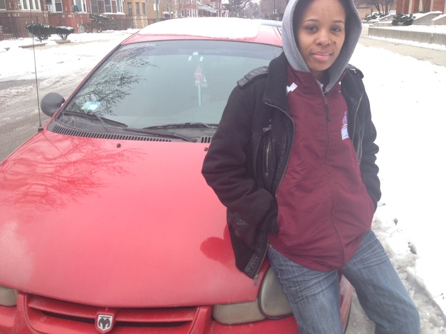 <p>Perspectives Charter School girls track coach Dominique Jacobs poses in front of her 2002 Dodge Neon, which was given to her by Margaret Klaus.</p>
