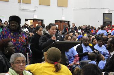 Parents, teachers and activists filled a church gymnasium to talk about school closures.