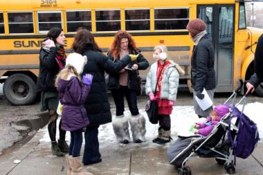 Parent Kristene Richardson, center, signs a petition against 'High Stakes Standardized Testing' outside Pritzker School Wednesday. Parents at 36 Chicago Public Schools went petitioning Wednesday, in hopes of getting the Board of Education to limit its array of standardized tests that some believe have taken too much time away from other classroom.