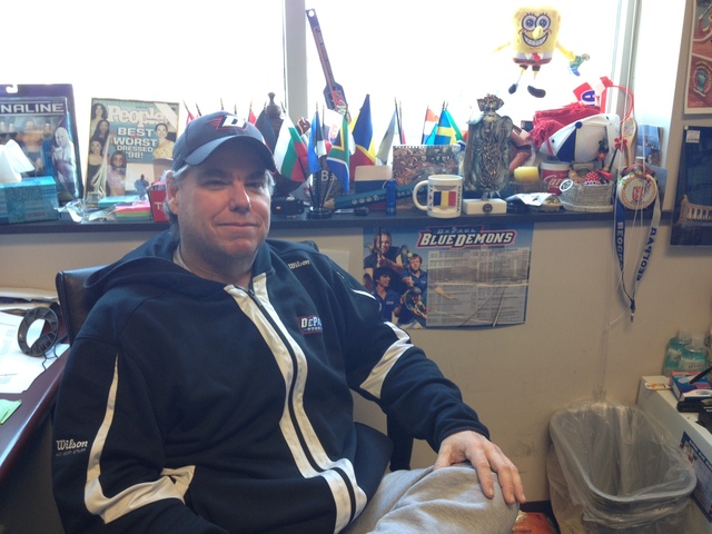 <p>DePaul women's tennis coach Mark Ardizzone poses in his office. Flags from the numerous European countries Ardizzone has visited on recruiting trips are in the background.</p>
