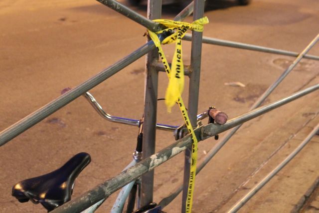 <p>A small strip of police tape is tied to the scaffolding beneath the historic Coyote Building on the northwest corner of Milwaukee and North Avenues hours after a police-involved shooting occurred across the street, in front of a bus stop at 1603 N. Milwaukee Ave.</p>
