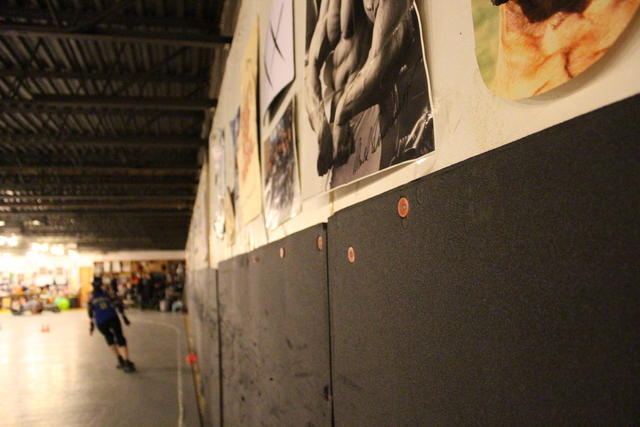 <p>A cement wall stands just inches from the Windy City Rollers' practice track.</p>
