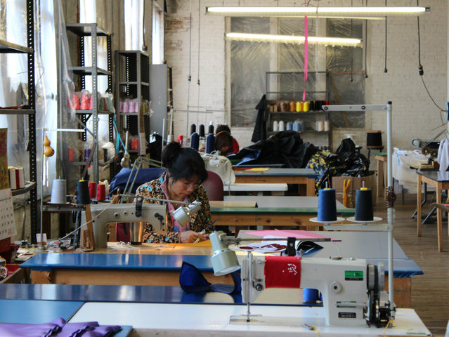 <p>A team of seamstresses works to sew designs onto what will become flags.</p>
