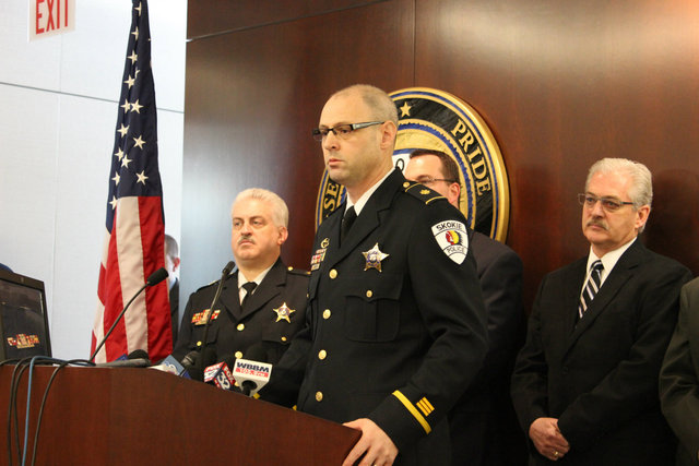 <p>Skokie Police Department Commander of Investigations Brian Baker flanked by members of the Skokie Police Department and Chicago Police Department.</p>
