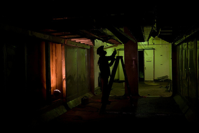 <p>A worker removes equipment to pave way for more room inside The Plant, a former meatpacking facility at 1400 W. 46th St.</p>
