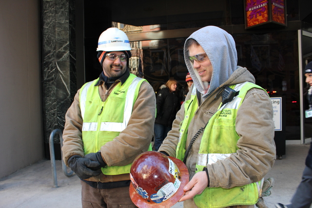 <p>Pete Brown and John Paul Youpal were sprinkled with water from firehoses while working at the construction site next door. Youpal shows off frozen water droplets on his hard hat.</p>
