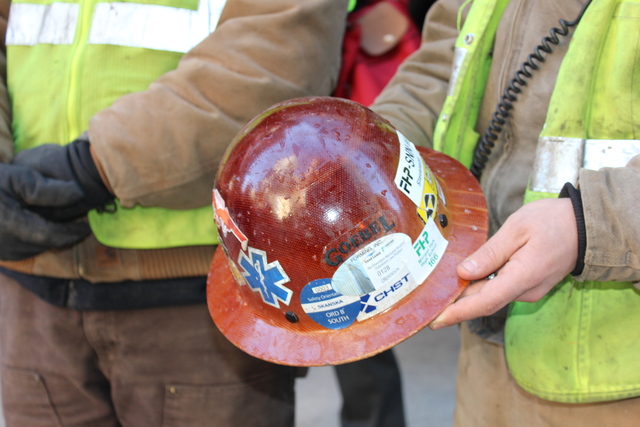 <p>Construction worker John Paul Youpal, who was working in a building next to the condominium building that caught fire, shows off frozen water droplets on his hard hat.</p>
