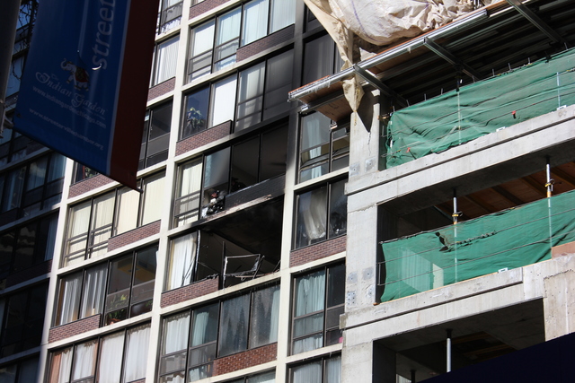 <p>Fire crews cleared out remaining glass from broken windows on the 7th and 8th floors of 230 E. Ontario St.</p>
