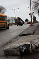 <p>A discarded mattress blocks the sidewalk on 106th Street at the Calumet River as a school bus drives past.</p>
