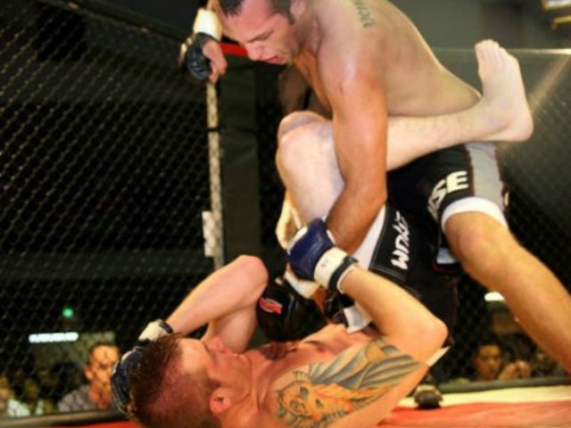 <p>Vaughn Camacho, top, throws a punch against Cory Linhart on May 30, 2009, in a fight that ended in a draw. Camacho, an English teacher at Lake View High School, is 6-2-1 as a Mixed Martial Arts amateur fighter.</p>
