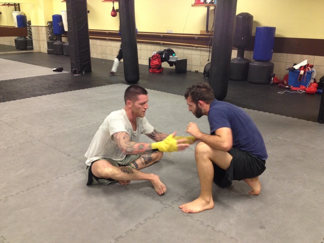 <p>Vaughn Camacho, right, trains with Tom Redmond at the Fitness Formula Club in Old Town.</p>
