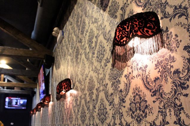 <p>Vintage filigree wallpaper and lights with fringes are juxtoposed against 11 flat-screen TVs at High Noon Saloon, a new sports bar-focused restaurant coming to a space that formerly housed People Tapas at 1650 N. Milwaukee Ave. in Wicker Park.</p>
