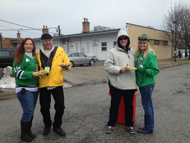<p>Maria and her friend Mary Floey serve food to security personnel near Maria's house party on 105th Street near the parade route.</p>
