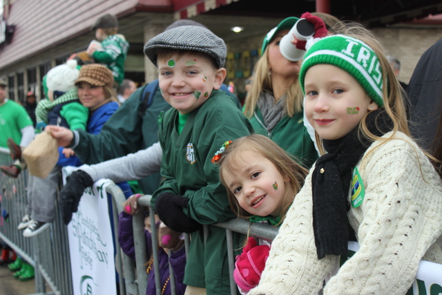 <p>Mac Murzyn, 7, looks on as a float from his school passes at the 2013 South Side Irish Parade.</p>
