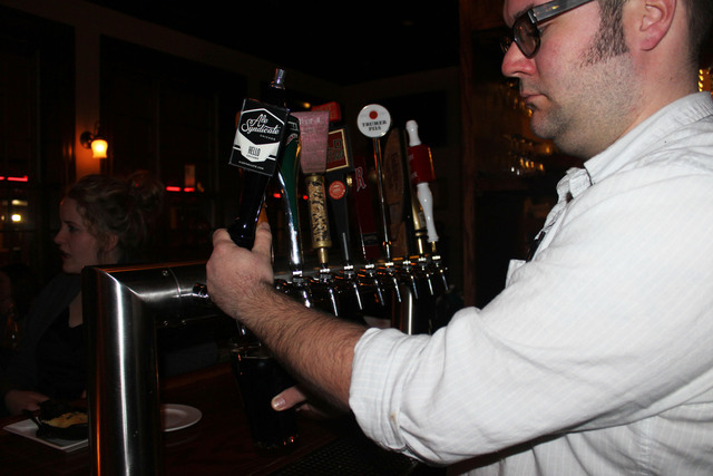 <p>John Von Tolley pours a Richie Imperial Stout on Wednesday at Owen and Engine, 2700 N. Western Ave.</p>
