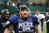 <p>Enforcers linebacker, Chicago police officer Carl Suchocki takes a break in between plays during practice.</p>
