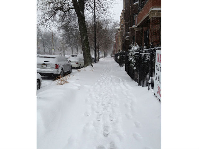 <p>Footprints can be seen in the snow in the 3500 block of South King Drive Tuesday.</p>

