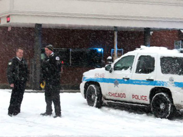 <p>Police stand outside a North Community Bank branch at 2000 W. Division St. Tuesday. The bank was believed to have been robbed by the "Mummy Bandit," according to the FBI.</p>
