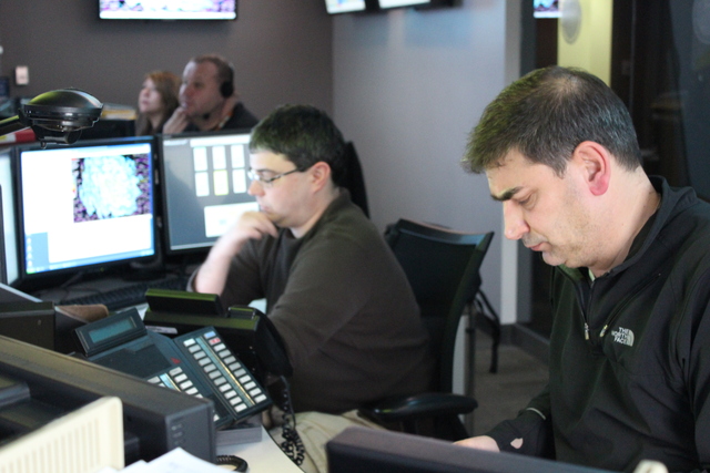 <p>Workers monitor the storm at the city's Office of Emergency Management and Communications Tuesday.</p>
