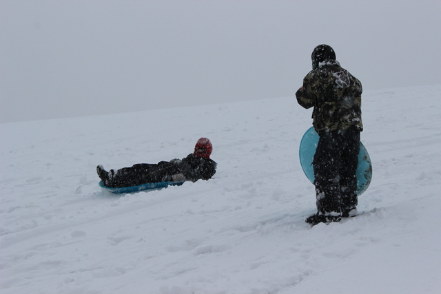 <p>Children go sledding in the snow Tuesday afternoon at Palmisano Park in the city's Bridgeport neighborhood.</p>
