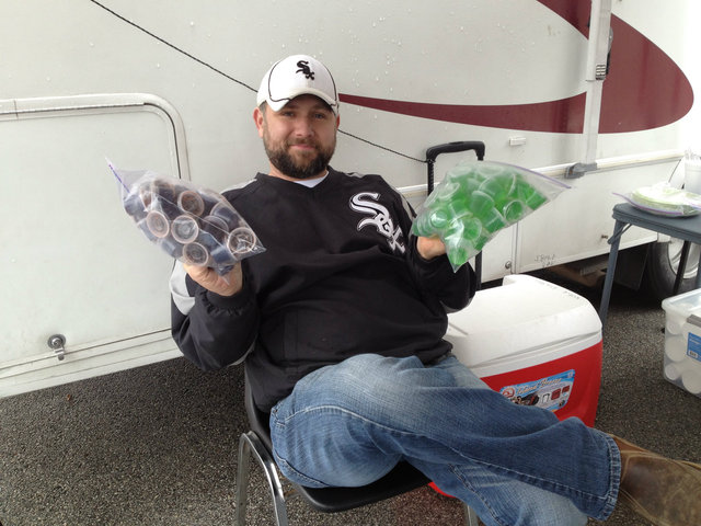<p>A family friend shows off green and black Jell-O shots at the Winters lot party off of 107th Street and Western Avenue.</p>
