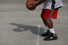 A teenager plays basketball in Garfield Park.