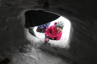Otti Boyle, 3, plays in an igloo built in an Andersonville backyard earlier this year. Chicago Public Schools closed again this week due to the extreme cold.