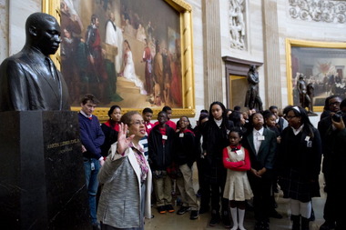  US Congressional Delegate Eleanor Holmes Norton of Washington, DC, speaks with students about Black History Month alongside a statue of Martin Luther King, Jr., during a tour of the Rotunda at the US Capitol in Washington, DC, on February 20, 2014.  