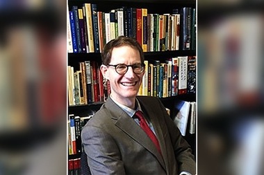 Graham Peck, a history professor at Saint Xavier University, is participating in a seminar titled
