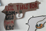 <p>Cardboard pistol includes directions, "Use this for Zombies not on Kids."</p>
