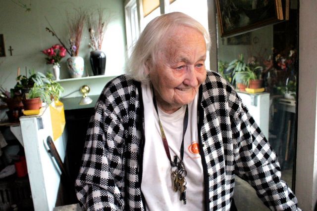 <p>Marcella walks to the window in her sunroom, so that she can point to the spot in her backyard where her longtime upstairs tenants had their wedding reception party.</p>
