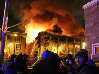 <p>Firefighters continue to douse water on a warehouse in Bridgeport the morning after the South Ashland Avenue building was engulfed in flames.</p>