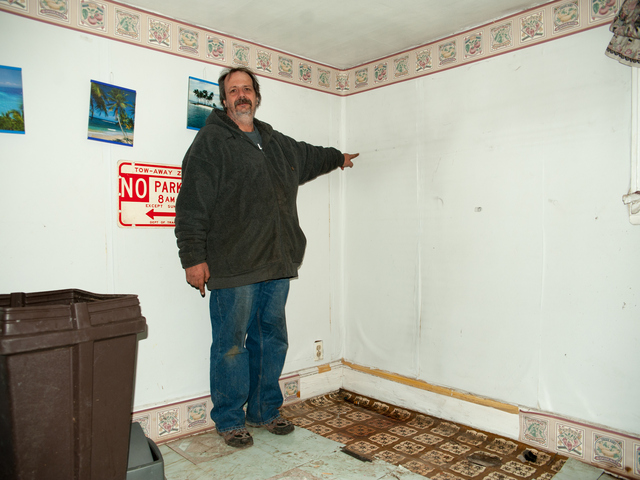 <p>John Greenholtz points to a watermark in his basement at 95-19 159th Avenue, showing how high the flood waters rose on Tuesday November 06th, 2012.</p>
