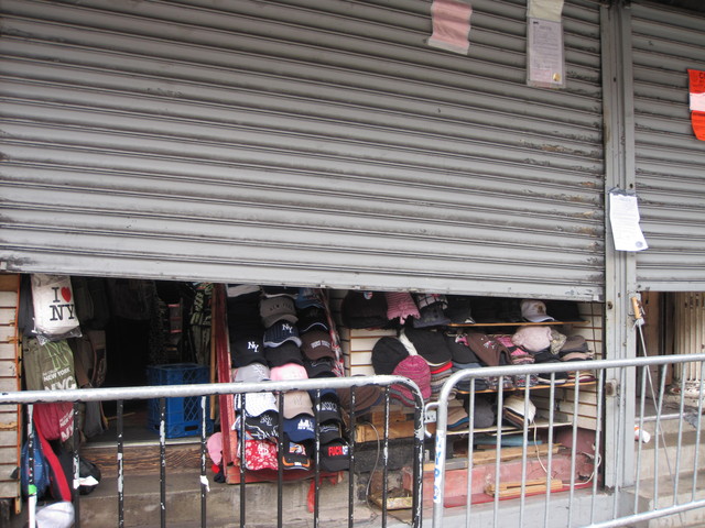 <p>Shuttered storefronts on the south side of Canal Street between Broadway and West Broadway. Police raided 10 buildings housing 31 stalls on Dec. 8, 2009, seizing knock-off handbags, watches and wallets as a part of crackdown on counterfeit sellers in the area.</p>
