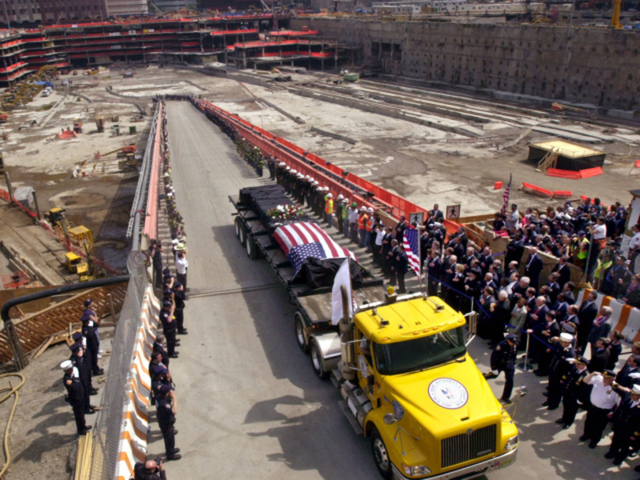 A flatbed trailer carrying the flag-draped last steel beam, which was once part of the World Trade Center towers, leaves the work site and formally marks the end of the recovery effort at ground zero on May 30, 2002.