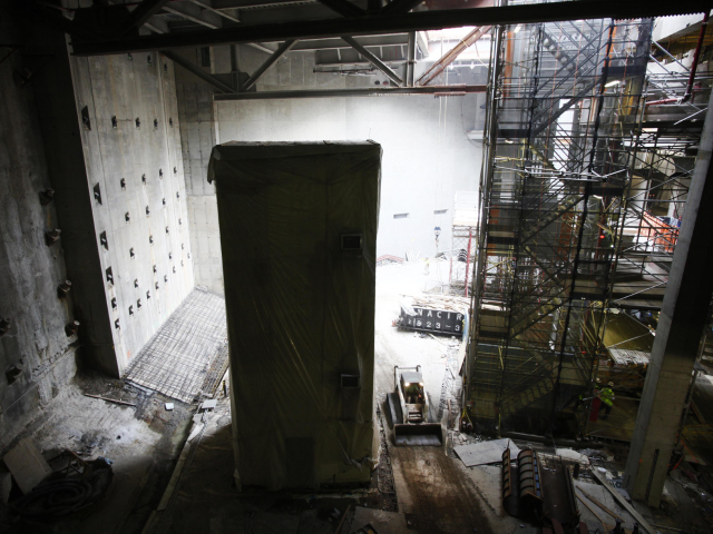 A bulldozer passes the base of the