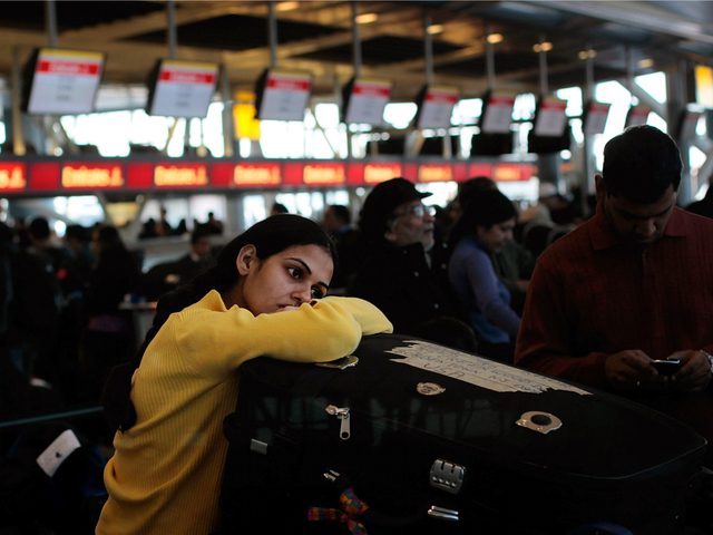<p>A traveler waits with her bags for check in to a flight at Terminal 4 following a major blizzard at John F. Kennedy International Airport December 27, 2010 in the Queens borough of New York City. A massive snowstorm crippled much of the Northeastern United States leaving up to a foot of snow for New York City and New England and left millions of holiday travelers stuck at airports and train stations around the eastern seaboard.</p>
