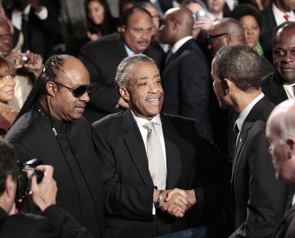 President Barack Obama, right, greets recording artist Stevie Wonder, left, and Rev. Al Sharpton, center, at the National Action Network's Keepers of Dream Awards Gala in New York, Wednesday, April 6, 2011.