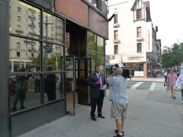 A news crew outside H&H Bagels reporting on the store's closure.
