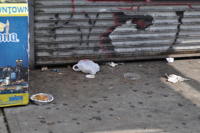 Trash outside a store on Sherman Avenue in Inwood.