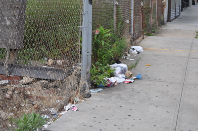 Trash piles up along Broadway in Inwood.