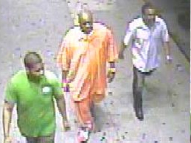 Another view of the suspect (center) and two men who were walking with him.