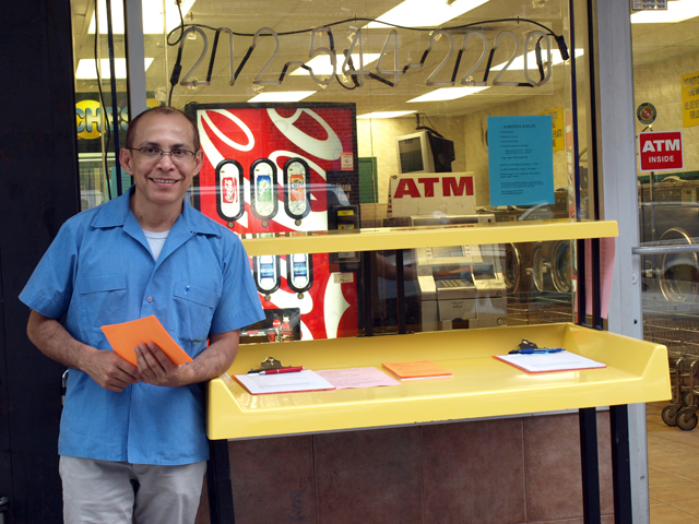 Hector Canonge signs up students for his free English classes at the Magic Touch Laundromat in Inwood on Tuesday, July 26, 2011. 