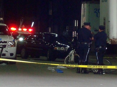 Cops inspect a bike fatality. 