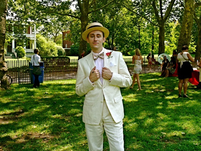 Matthew Karl Gale in a slim cut single-breasted peak lapel linen suit and an Italian   hard straw boater hat