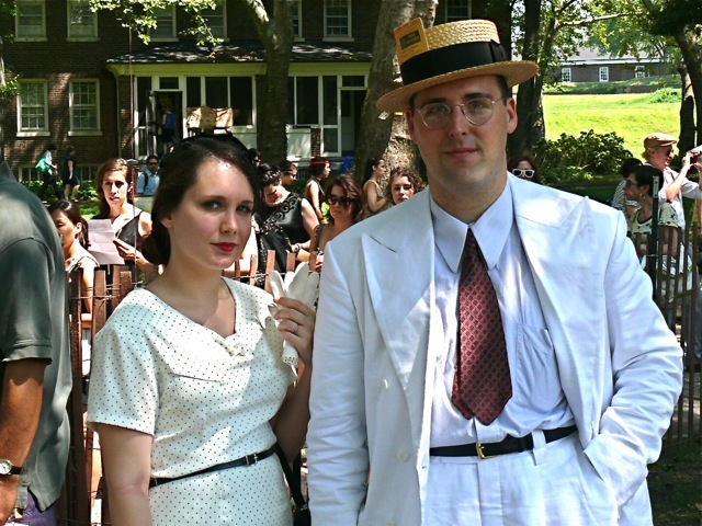 This is Street Chic's pick for the most authentic American look.  Her black and white pinpoint dress is a style seen in the late 20s, appropriately accessorized with summer shortie gloves. His peak lapel linen suit is worn with a classic point collar shirt and a hard straw boater hat.